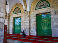 A Muslim woman prays at the Al-Aqsa Mosque in the Temple Mount  in Jerusalem, Israel on December 29, 2022. (