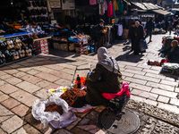 A woman sells local fresh vegetables and fruits at the street market in the Old City in Jerusalem, Israel on December 29, 2022. (