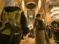 Policeman during Orthodox Christmas service in St. Volodymyr Cathedral in Kyiv, Ukraine, January 6, 2023 (