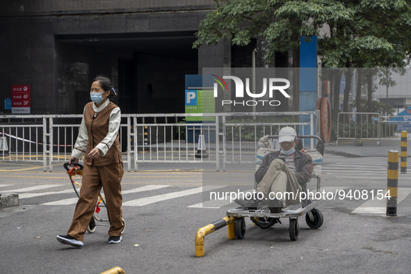People wearing a face mask walking down a street on January 8, 2023 in Shenzhen, China. China today lifts its requirement for inbound travel...