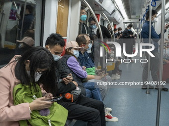 People wearing face masks riding on the metro on January 8, 2023 in Shenzhen, China. China today lifts its requirement for inbound travelers...