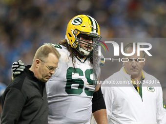 Green Bay Packers tackle David Bakhtiari (69) is helped back to the bench during the second half of an NFL football game against the Detroit...