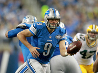 Detroit Lions quarterback Matthew Stafford (9) hands off during the second half of an NFL football game against the Green Bay Packers in Det...