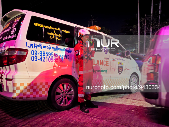 A rescue worker stands beside an ambulance after an ammonia gas leak occurred at an ice factory in Yangon, Myanmar on January 12, 2023. 