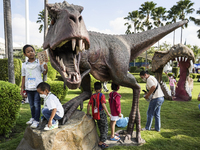 Children play a dinosaur figure model during the Children's Day celebration at Government House in Bangkok, Thailand, January 14, 2023. Chil...