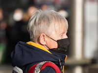 A woman wears a face mask at Cologne central station on 14 January 2023. (
