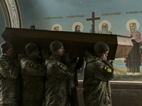 Relatives, friends and comrades attend a funeral ceremony for Oleksandr Grianyk, serviceman of Azov regiment, who was killed on May 8 defend...
