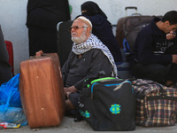 A Palestinian man sits on his luggage as he hopes to cross into Egypt at the Rafah crossing between Egypt and the southern Gaza Strip April...