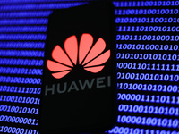 Huawei logo displayed on a phone screen and a binary code displayed on a screen are seen in this illustration photo taken in Krakow, Poland...