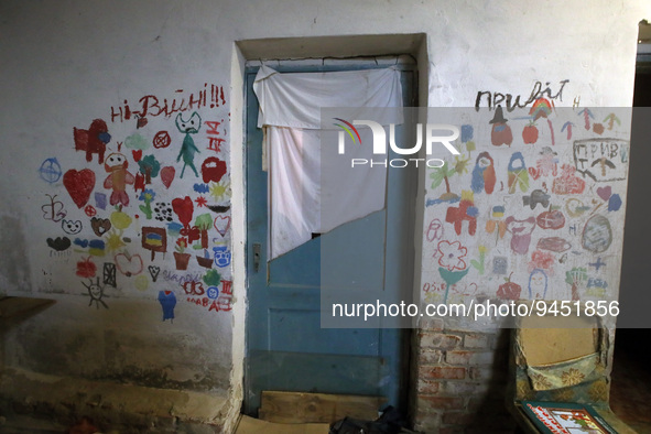 YAHIDNE, UKRAINE - JANUARY 14, 2023 - Children's drawings cover the wall of the school basement where Russian soldiers held 299 adults and 6...