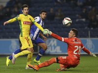 Pacos Ferreira's Portuguese defender Helder Lópes (L) with Porto's Mexican forward Jesús Corona shooting for goal during the Premier League...