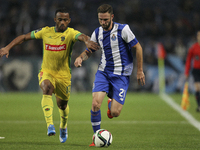 Porto's Mexican defender Miguel Layún (R) vies with Pacos Ferreira's Brazilian forward Edson Farias (L) during the Premier League 2015/16 ma...