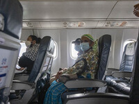 Passengers wearing facemask during the flight. Inside the cabin of a Yeti Airlines ATR 72 propeller aircraft as seen on a flight from Pokhar...