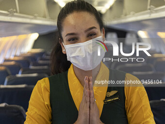 A flight attendant wearing a facemask inside the cabin of Yeti Airlines ATR 72-500. Flight attendant or air stewardess / air hostess is a me...