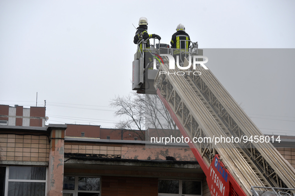BROVARY, UKRAINE - JANUARY 18, 2023 - Two rescuers use an aerial ladder at the scene of the fatal helicopter crash at a kindergarten in Brov...