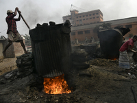 Laborers boil small pieces of leather to glue at a tannery area in Hazaribag, Dhaka, Bangladesh on January 18, 2023. Though many leather fac...