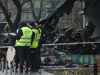 Experts and criminologists work at the site of a helicopter crash near kindergarten,  in the Brovary town, in the outskirts of Kyiv, Ukraine...