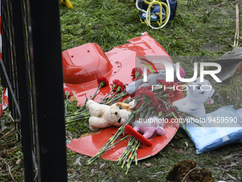 People leave Flowers and toys on a fragment of a helicopter that crashed near kindergarten,  in the Brovary town, in the outskirts of Kyiv,...