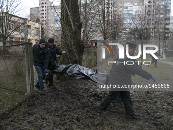 Municipal workers carry bodies of a helicopter crash victims from a kindergarten in the Brovary town, in the outskirts of Kyiv, Ukraine, Jan...