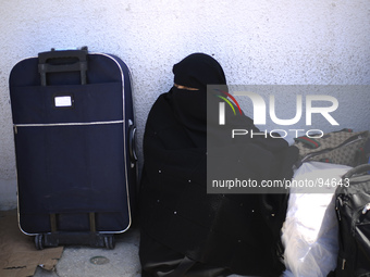 A palestinian woman waits to cross into Egypt at Rafah crossing between Egypt and Gaza Strip in Rafah town, southern Gaza strip on April 29,...