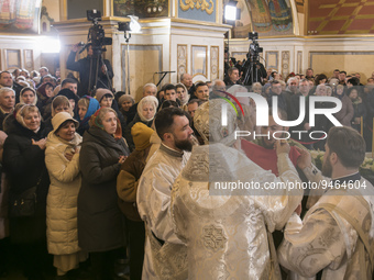 Believers receive Holy Communion during the Orthodox Christian feast of Epiphany service led by Metropolitan Epiphanius I of Ukraine, head o...