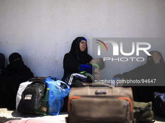 Palestinians wait to cross into Egypt at Rafah crossing between Egypt and Gaza Strip in Rafah town, southern Gaza strip on April 29, 2014. E...