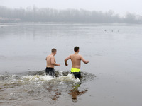 Ukrainians take a dip in icy water during celebration of the Orthodox Epiphany Christian feast in Dnipro River of Kyiv, Ukraine 19 January 2...