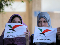 Palestinians hold Palestine flags during a protest against administrative detention of Palestinian prisoners In Israeli jails, in front of t...