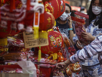 Shoppers look at rabbit-themed ornaments and Chinese decorations which are offered for sale ahead of the Chinese Lunar New Year celebrations...