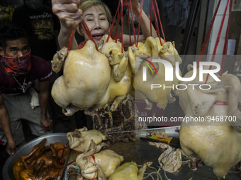 People purchase roasted duck and chicken at a street restaurant ahead of the Chinese Lunar New Year celebrations in Chinatown, Bangkok, Thai...