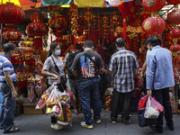 Shoppers look at rabbit-themed ornaments and Chinese decorations which are offered for sale ahead of the Chinese Lunar New Year celebrations...