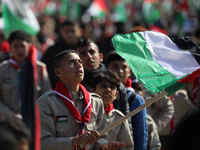 Palestinian Scouts wave national flags as they march in support fellow Palestinians in Jerusalem and the West Bank and Palestinian prisoners...