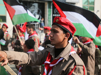 Palestinian Scouts wave national flags as they march in support fellow Palestinians in Jerusalem and the West Bank and Palestinian prisoners...