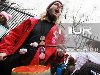 A man beats on drums before being assaulted by an anti-abortion rights demonstrator outside of the White House during the Women's March in W...