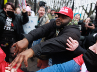 An anti-abortion rights demonstrator, red hat in center, assaults an abortion rights supporter outside of the White House during the Women's...