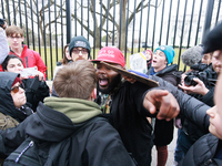 An anti-abortion rights demonstrator, red hat in center, argues with a person after assaulting an abortion rights supporter outside of the W...