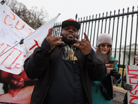 An anti-abortion rights demonstrator flashes hand symbols after assaulting an abortion rights supporter outside of the White House during th...