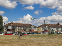Aer Lingus Airbus A320 aircraft as seen flying on final approach over the houses of Myrtle avenue in London, a famous planespotting location...