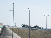 Battle tanks are seen to be transported on a trail over the highway with police escort near the border crossing with Ukraine Korczowa - Krak...
