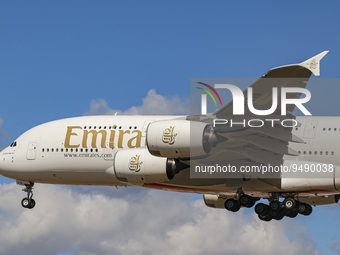 Emirates Airbus A380 aircraft as seen flying on final approach during a blue sky summer sunny day with some clouds, arriving from Dubai DXB...