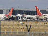 Air India Boeing 787 Dreamliner aircraft as seen at the gates of the terminal of London Heathrow airport during a cloudy day from  Myrtle Av...
