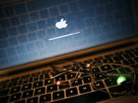 Glasses on a MacBook keyboard and an Apple logo on the screen in Athens, Greece on January 24, 2023. (