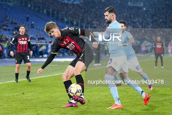 Charles De Ketelaere of AC Milan and Elseid Hysaj of SS Lazio compete for the ball during the Serie A match between SS Lazio and AC Milan at...