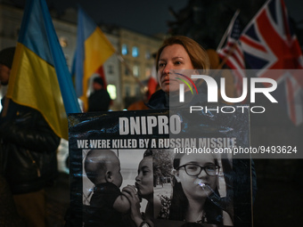 A protester holding a poster with words 'Dnipro, we were killed by a russian missile' is seen during the 'Protest in Support of Ukraine' on...