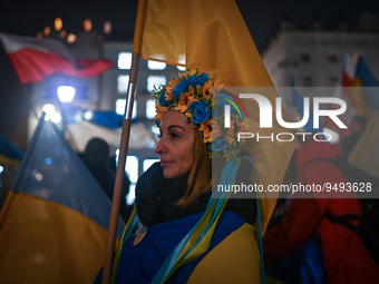 A protester holding a Ukrainian national flag is seen during the 'Protest in Support of Ukraine' on the Main Market Square in Krakow, on the...