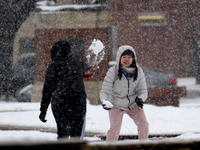 University students play with snow  amid heavy snow fall at Norman, Oklahoma, USA. 24 January 2023. (