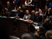 The benches of the government majority with PM Elisabeth Born in the centre, looking behind,  during the question session to the government,...