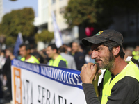 A worker takes part in a protest outside the city administration building in Limassol. Cyprus, Thursday, January 26, 2023. Thousands of work...