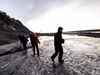 People walk over the ice in Vatnajökull Glacier National Park in Iceland on January 26, 2023. -Vatnajokull glacier, spelled Vatnajökull in I...