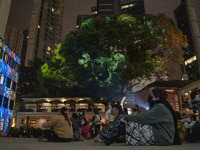 People watching patterns projected onto Tai Kwun during the InnerGlow 2023 light show on January 26, 2023 in Hong Kong, China. InnerGlow 202...